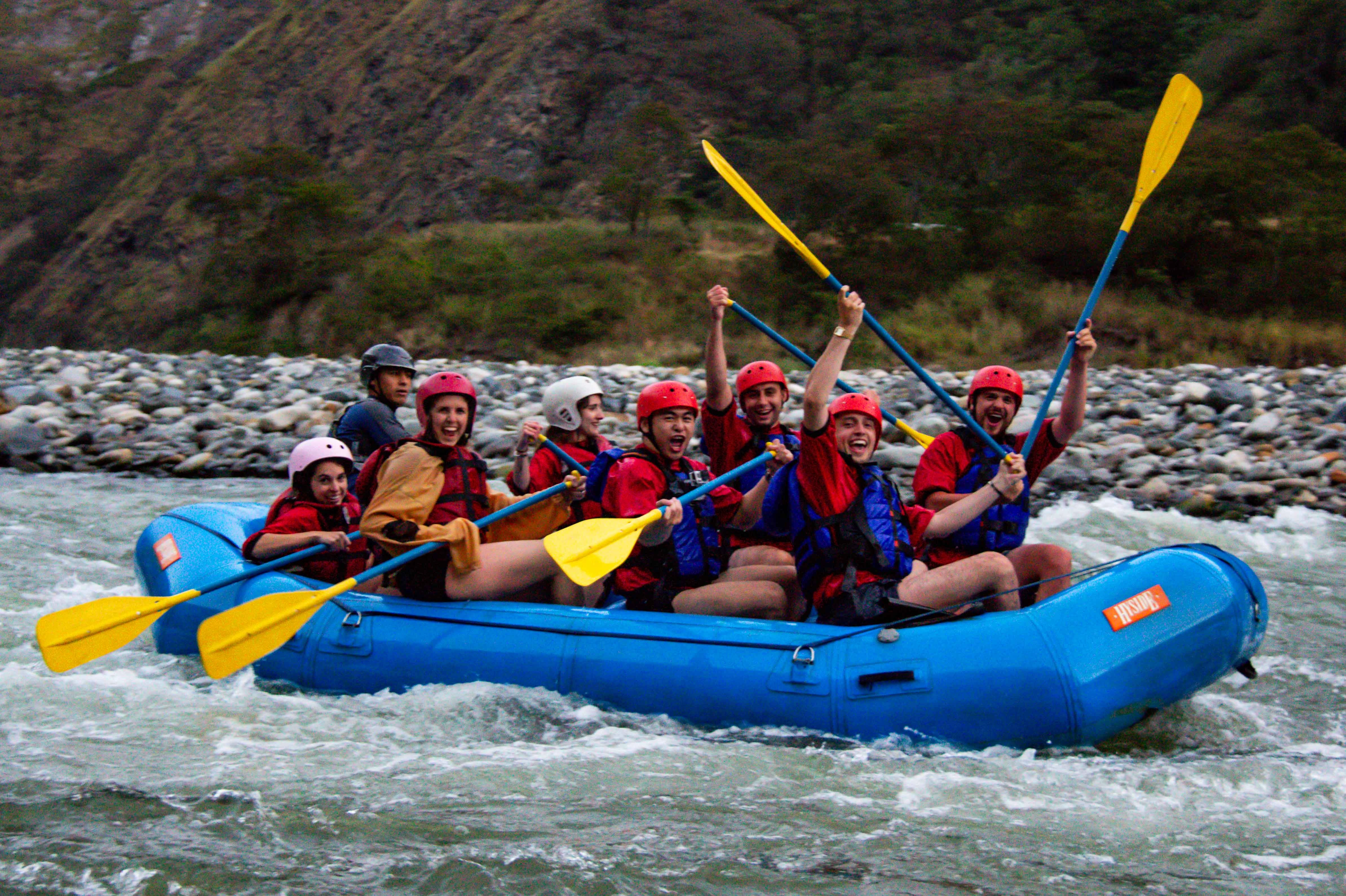 Group of tourists rafting down the river surrounded by mountains in Cusco, Peru | Conde Travel Adventures