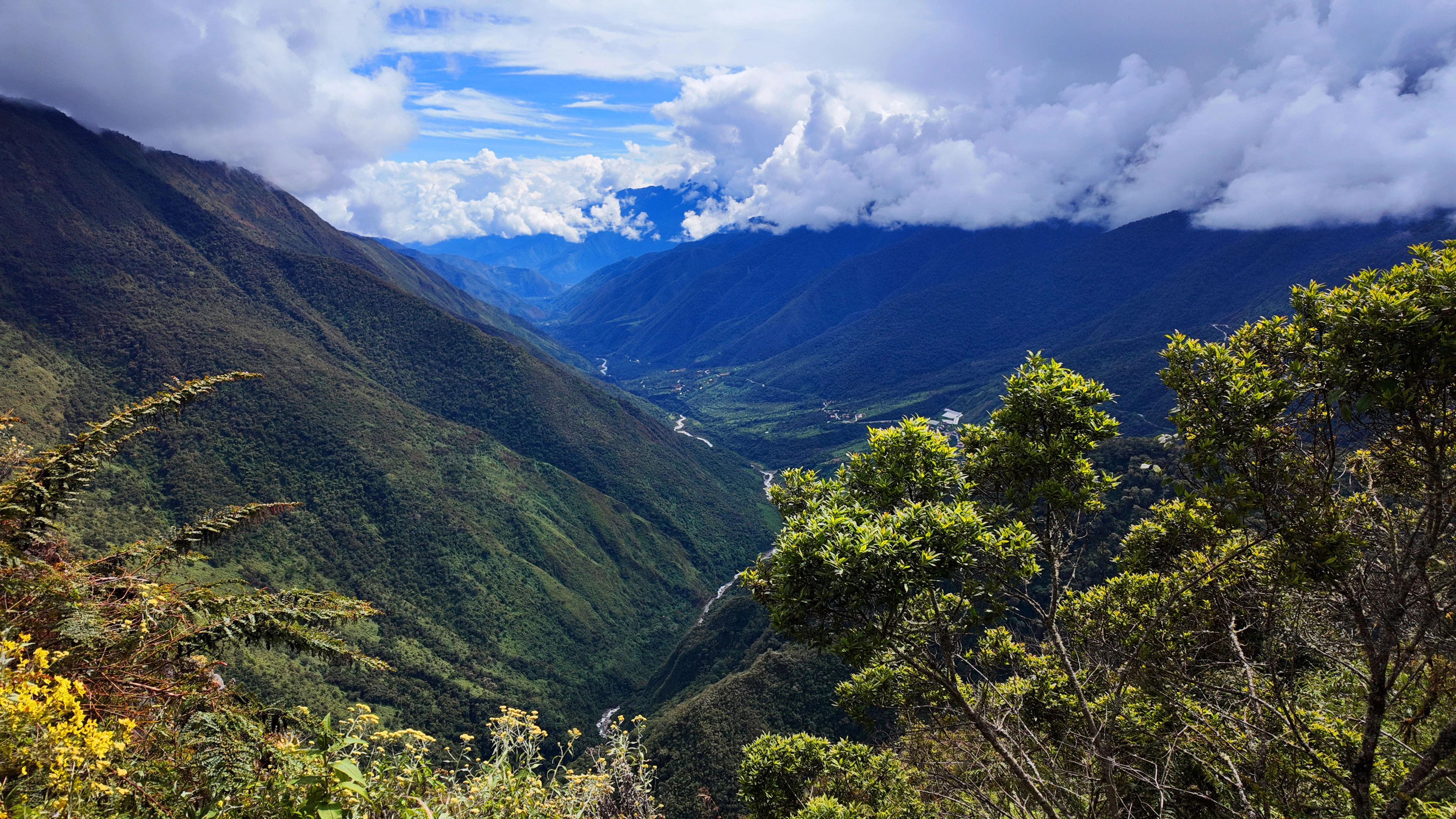 Panoramic view of lush green landscape at Abra Malaga viewpoint, part of the Inca Jungle trail in Peru | Conde Travel Adventures