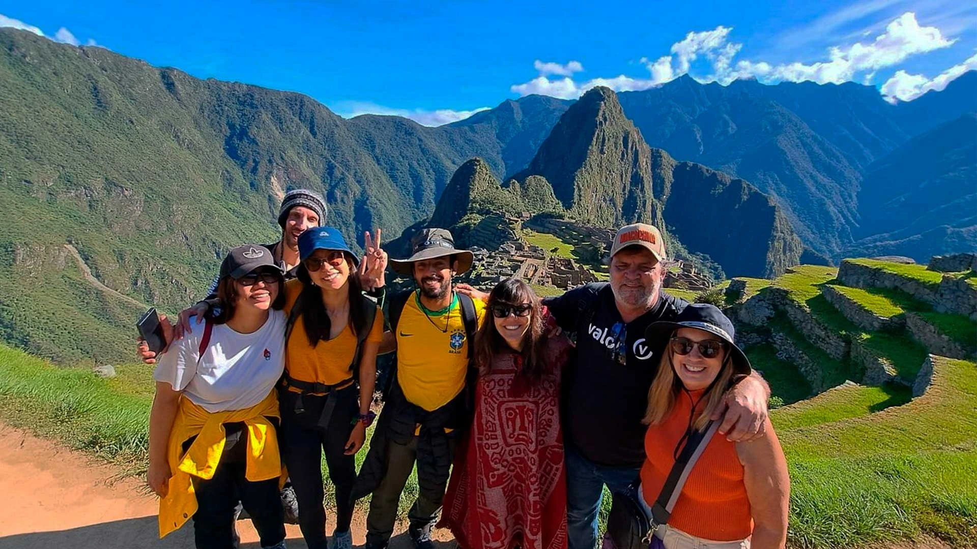 Group of visitors at Machu Picchu with Andean mountains in the background | Conde Travel Adventures