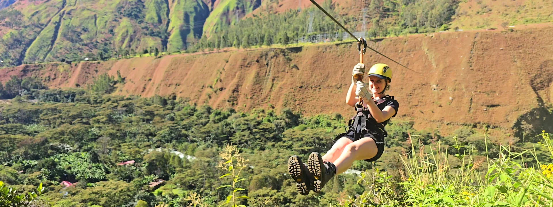 Traveler enjoying a thrilling zipline ride through lush forest on the Inca Jungle route to Machu Picchu | Conde Travel Adventures