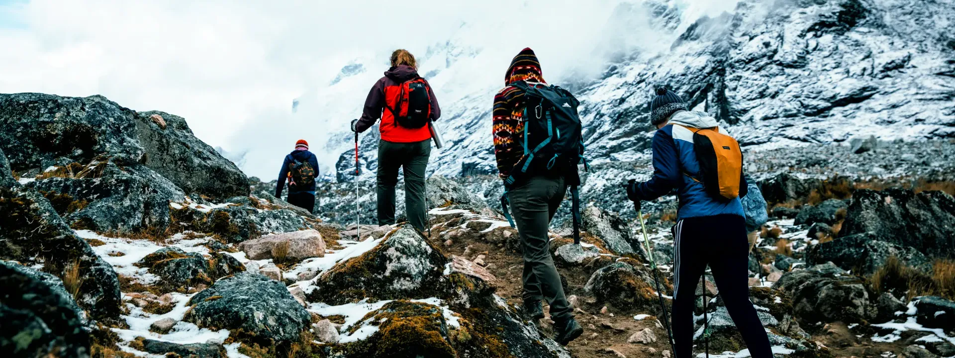 Group of hikers trekking through the snowy Andes on the Salkantay Trail in Peru | Conde Travel Adventures