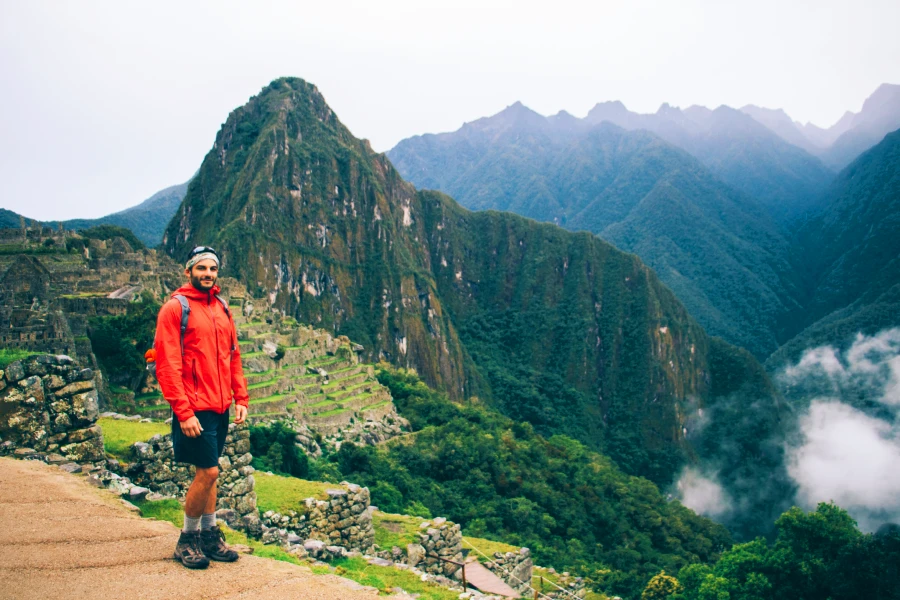 Hiker standing at a viewpoint admiring Machu Picchu early in the morning | Conde Travel Adventures