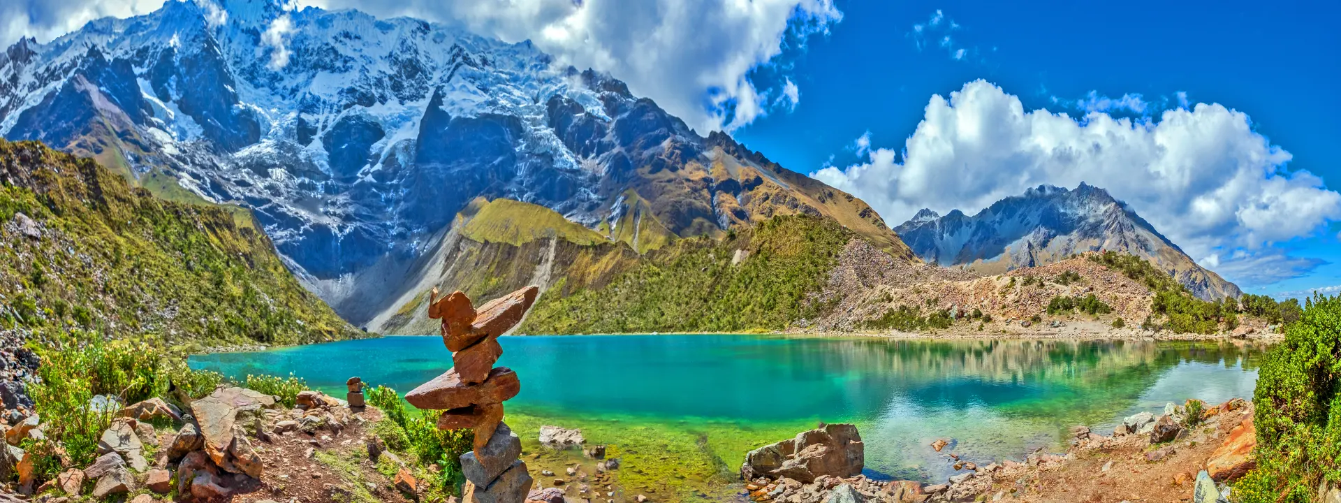 Turquoise waters of Humantay Lake surrounded by snow-capped peaks on the Salkantay Trek | Conde Travel Adventures