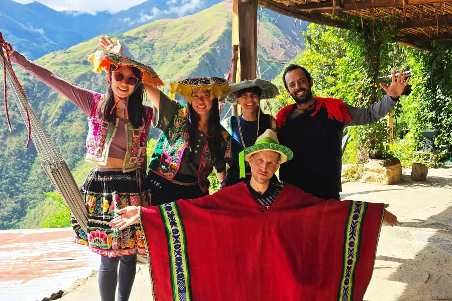 Travelers enjoying the Inca Jungle tour in Peru with traditional clothing and mountain views | Conde Travel Adventures