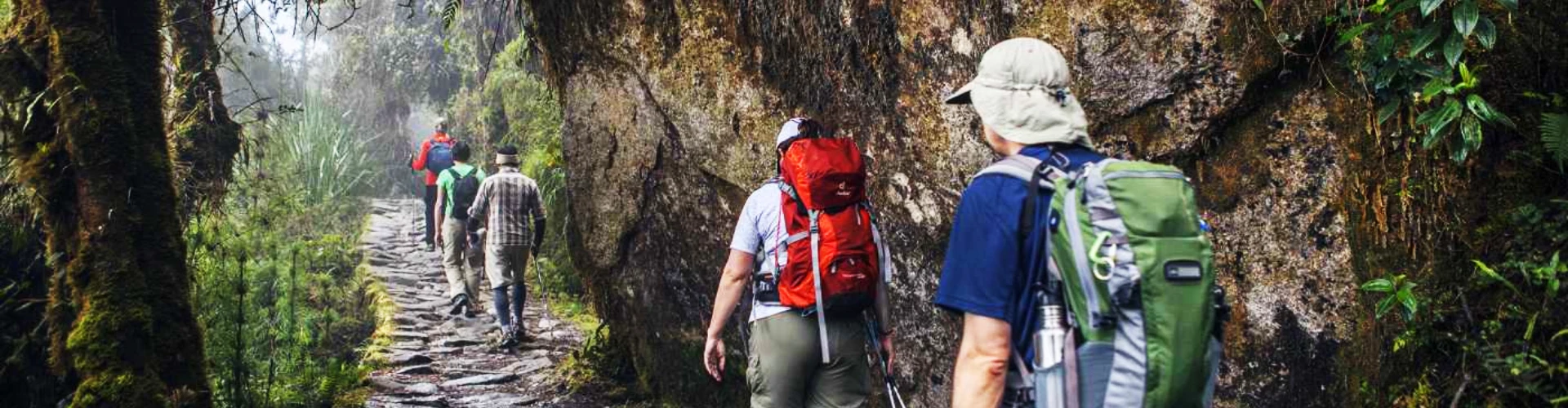 Hikers walking along the Inca Trail in Peru, surrounded by mountains on the way to Machu Picchu | Conde Travel Adventures