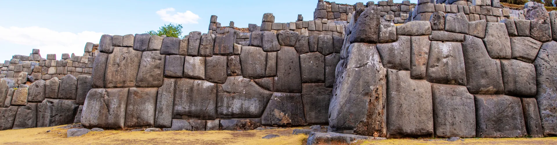 Massive stone walls of the Sacsayhuamán fortress overlooking Cusco city in Peru | Conde Travel Adventures