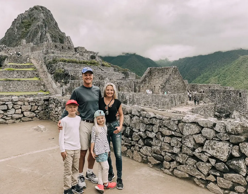 Family with children visiting Machu Picchu ruins in Peru | Conde Travel Adventures