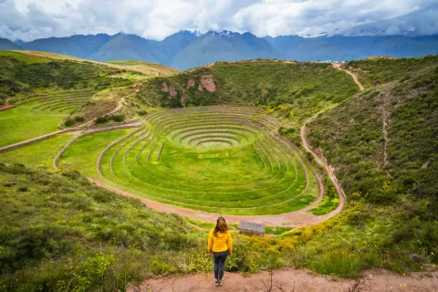 Moray Terraces – Inca Agricultural Laboratory | Conde Travel Adventures Tourist admiring the circular Inca terraces at Moray in the Sacred Valley | Conde Travel Adventures