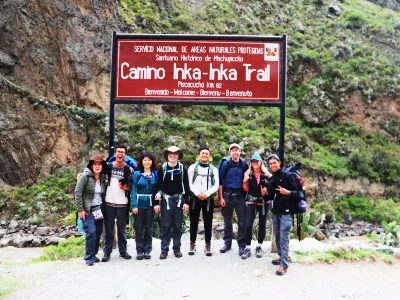 Group of hikers posing at the official entrance of the Inca Trail at KM 82 | Conde Travel Adventures