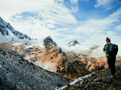 Solo hiker on the Salkantay Trek with snow-capped mountains in the background | Conde Travel Adventures